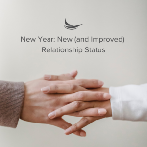 New Year: New (and Improved) Relationship Status. Two hands interlocking holding hands white background.